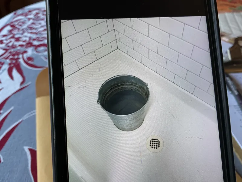 Shower bucket used to water flower beds!